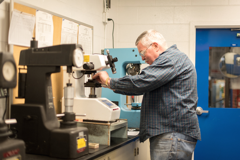 Metallurgist testing metal