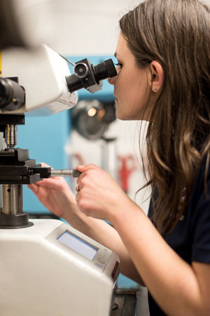 Metallurgist testing metal