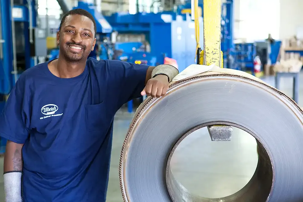 Ulbrich rolling mill employee with coil on crane