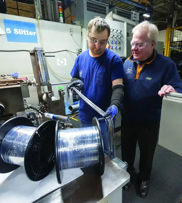 Ulbrich Slitter 5 Employees Inspecting Metal