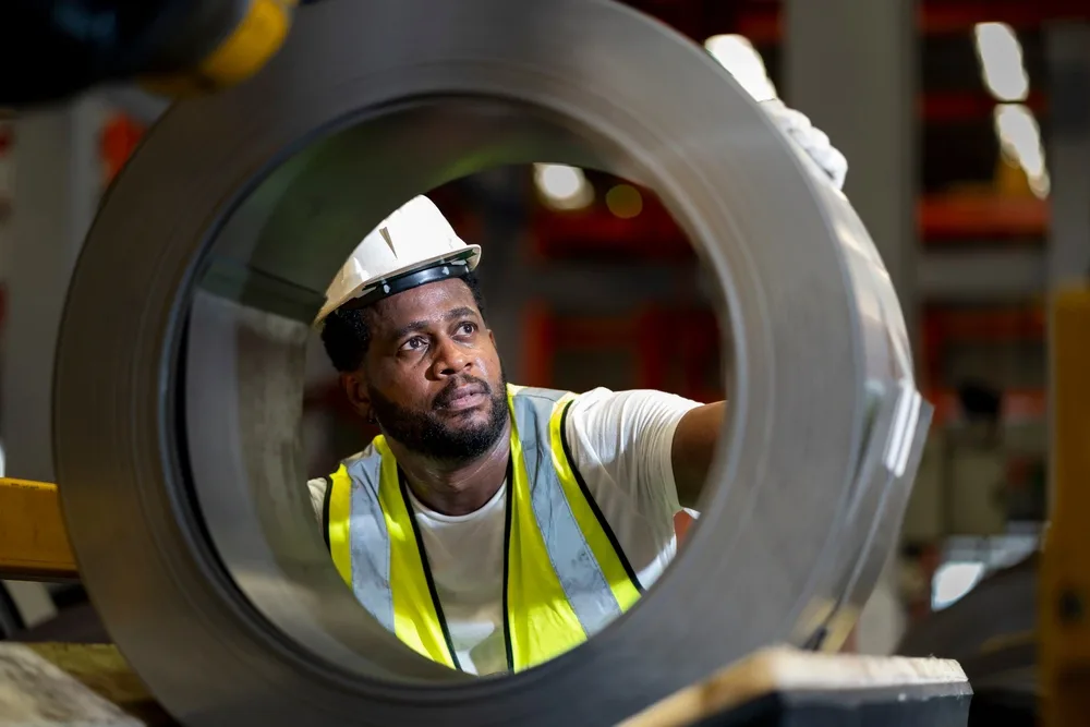 Worker inspecting coil