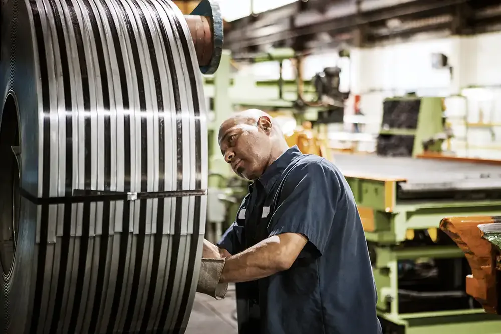 man checking metal sheet